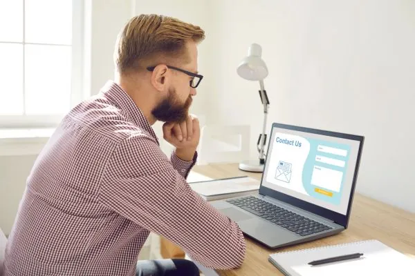 Man sitting thinking about contacting a remodelers through website contact form