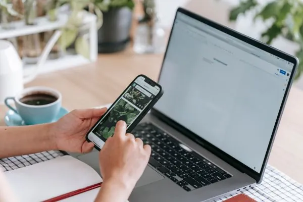 women browsing on mobile and laptop