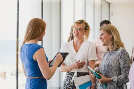 woman in blue networking with local businesses and homeowners